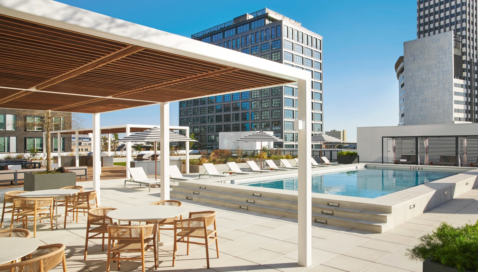 Roof-top pool deck with resort-style cabanas and modern furniture