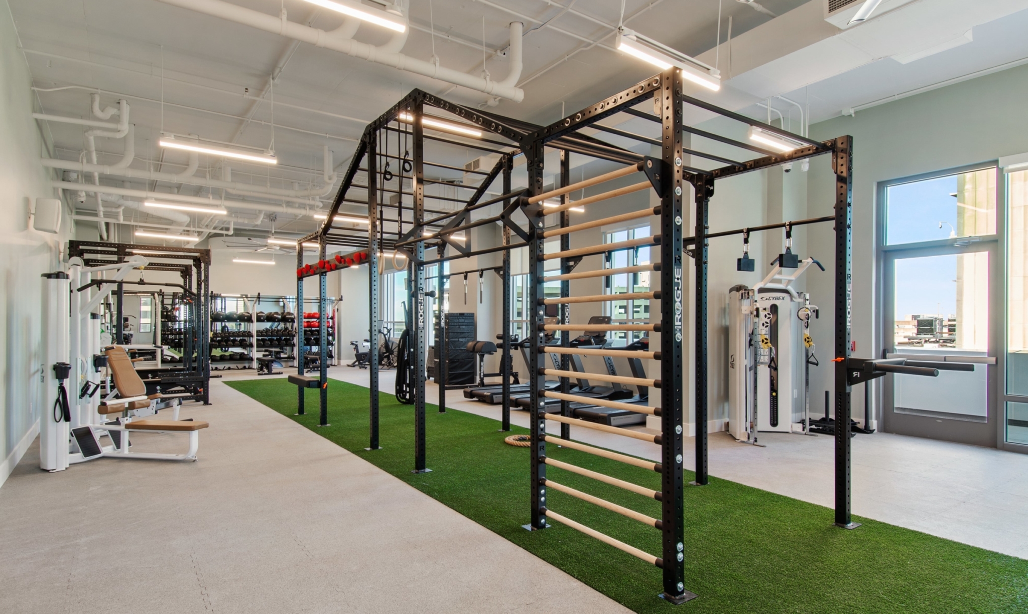 Fitness Center at The Odeon featuring cardio and weight equipment and a clean, bright space.